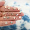 hand out holding different gemstone variations of the star charm