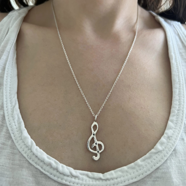 wearing-a-treble-clef-music-note-charm-neckace-elisa-solomon wearing a treble clef music note necklace