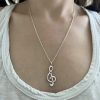 wearing-a-treble-clef-music-note-charm-neckace-elisa-solomon wearing a treble clef music note necklace