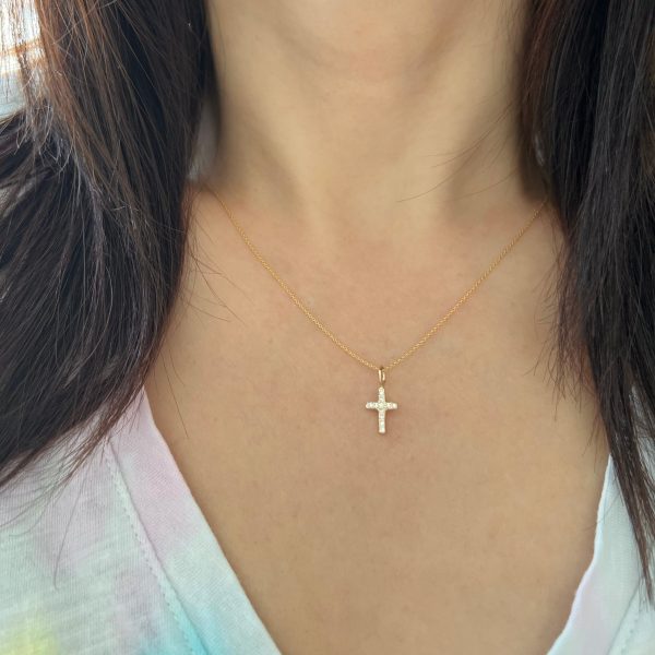 gold-diamond-gemstone-cross-charm-elisa-solomon-jewelry wearing the gold cross charm in 14k yellow gold with diamonds