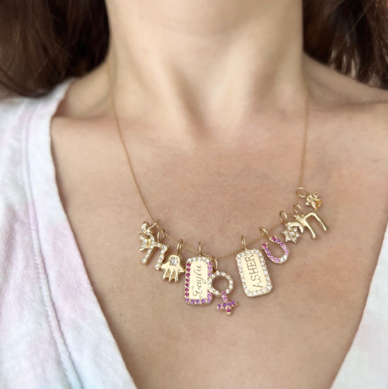 5 new charms by Elisa seen worn on a necklace