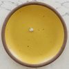 sterling silver egg charm on a yellow plate