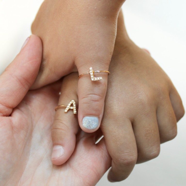 Mother and Daughter holding hands wearing the Letter Rings