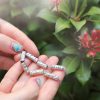 holding-the-tiny-gold-diamond-name-beads holding the platinum tiny name bead bracelets with diamonds