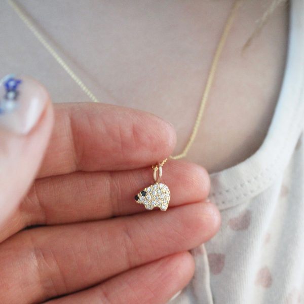 holding-the-gold-polar-bear-diamond-charm-necklace holding the gold polar bear diamond charm