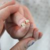 holding-the-tiny-gold-polar-bear-diamond-stud-earrings holding the tiny gold polar bear diamond stud earrings