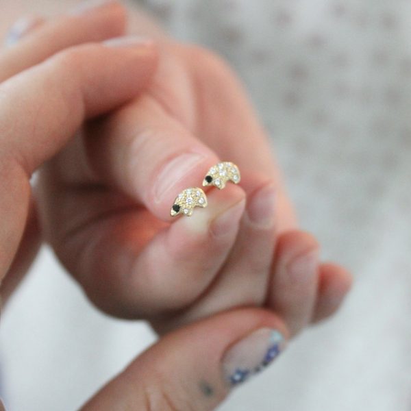 holding-the-tiny-gold-polar-bear-diamond-stud-earrings holding the tiny gold polar bear diamond stud earrings