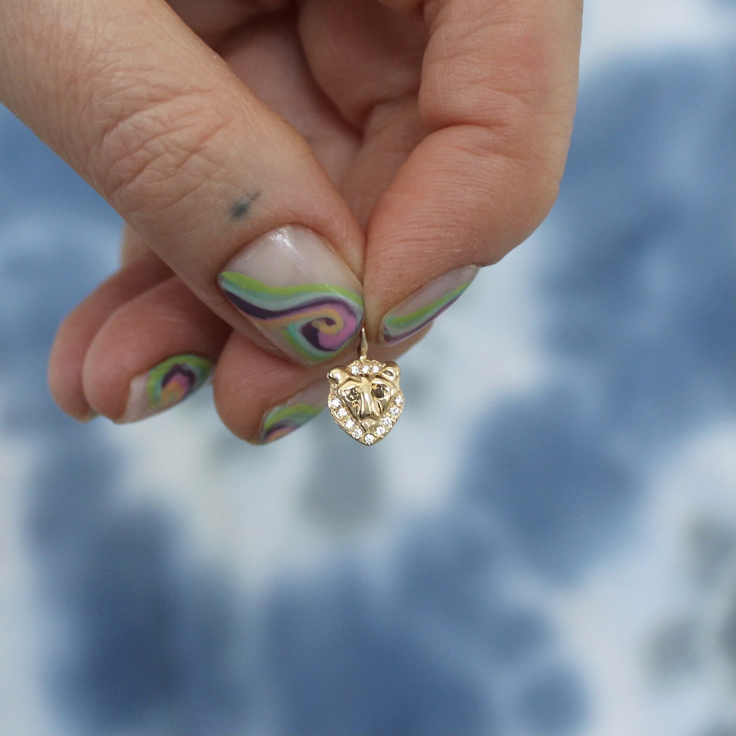 Holding the Lion Charm