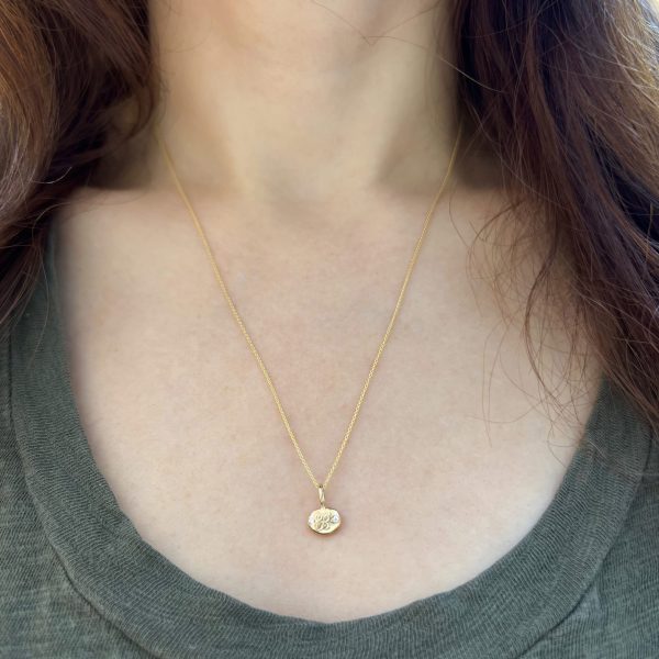 the-teeny-oval-charm-worn-around-elisas-neck wearing the teeny oval charm