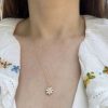wearing the 14k gold birthstone flower charm set with