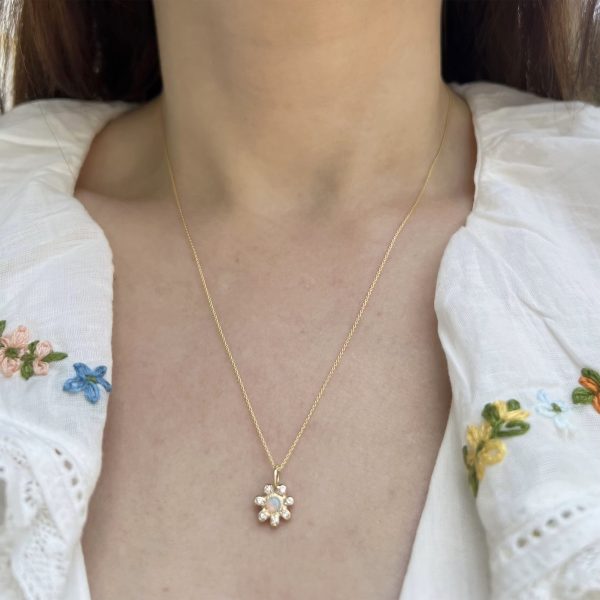 wearing the 14k gold birthstone flower charm set with