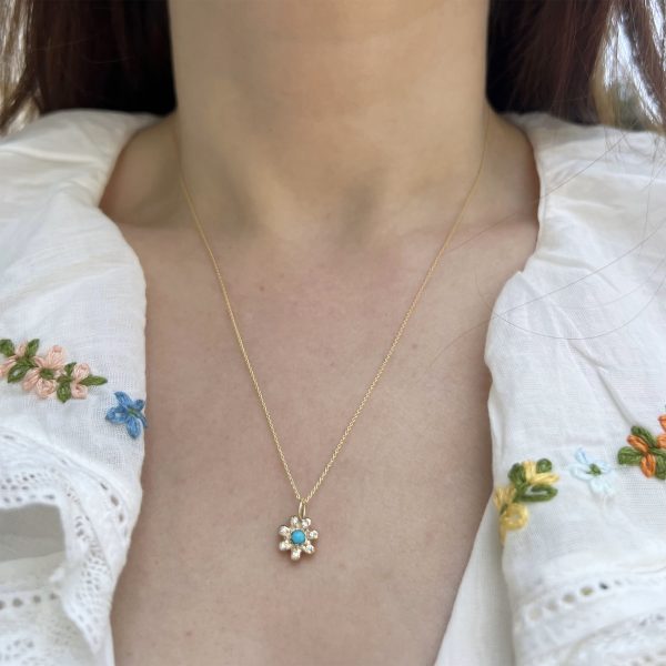 wearing the 14k gold birthstone flower charm set with