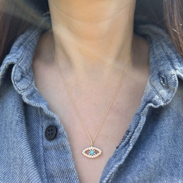 wearing the 14k yellow gold eye charm