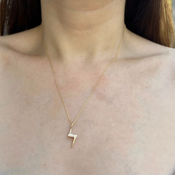 wearing the 14k yellow gold lighting bolt charm necklace