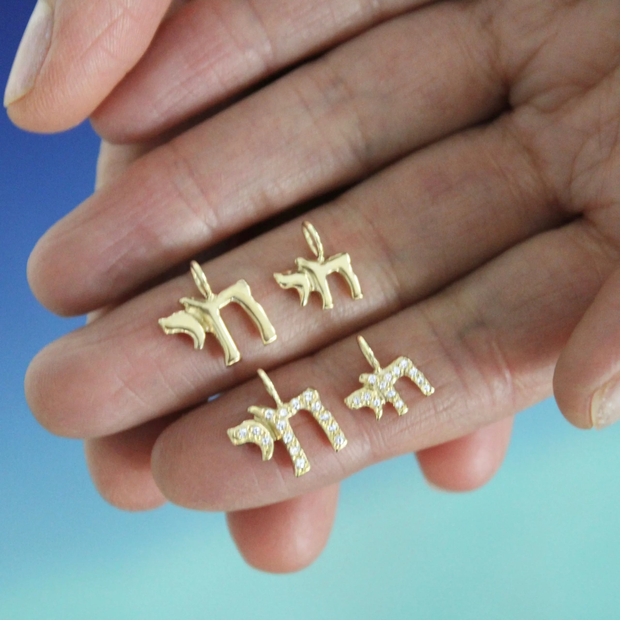 tiny chai symbol gold and diamond charms close-u holding in your hand